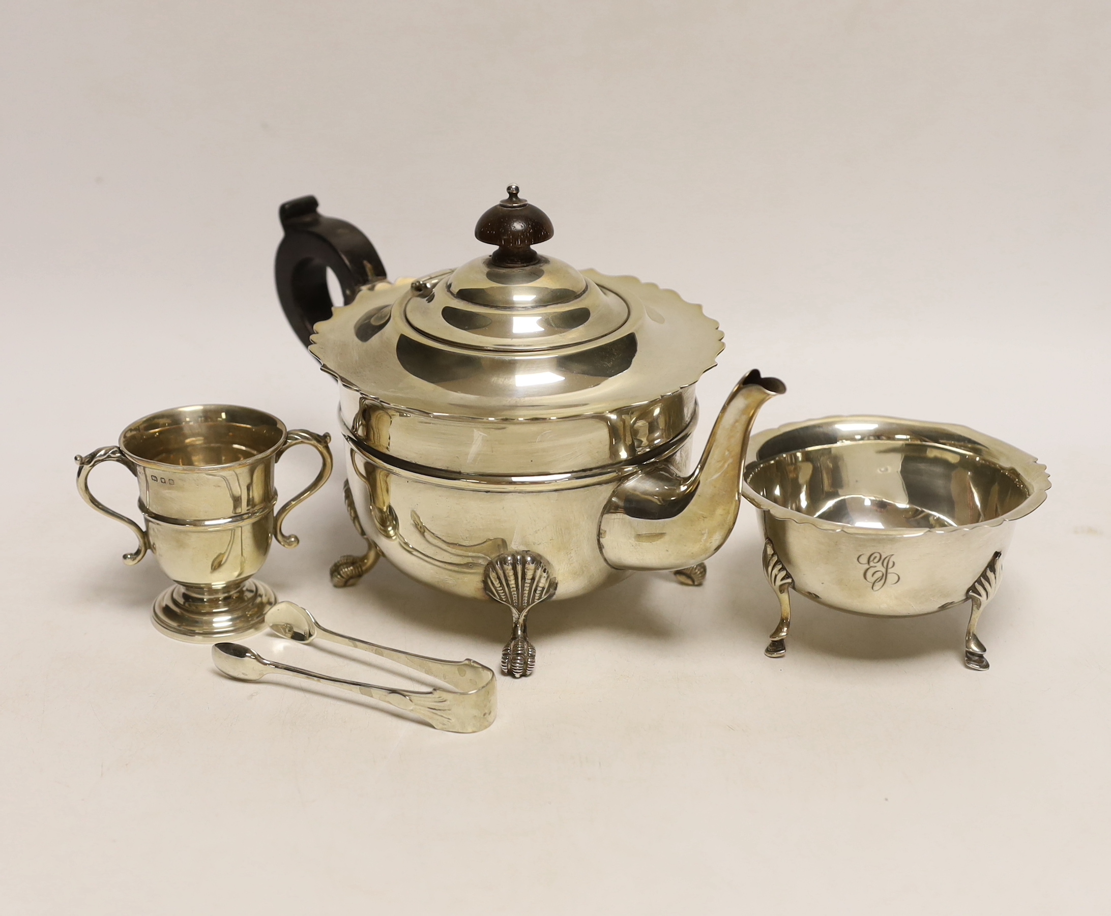 A George V silver teapot, J. Sherwood & Sons, Birmingham, 1913, an Irish silver sugar bowl pair of silver sugar tongs and a small silver two handled trophy cup, gross 18.7oz.